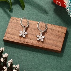 French style floral hoop earrings with sparkling zircons on a rustic wooden display