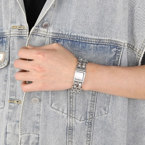Mens stainless steel link bracelet with silver hollow chain links on denim background