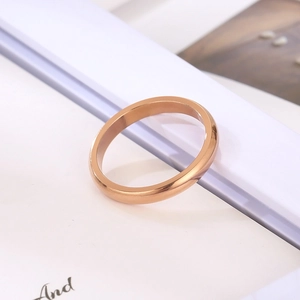Minimalist 3mm rose gold stainless steel round band ring on white decorative frame