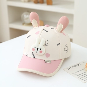 Detailed view of plush 3D bunny ears and cute rabbit print on pink kids baseball cap