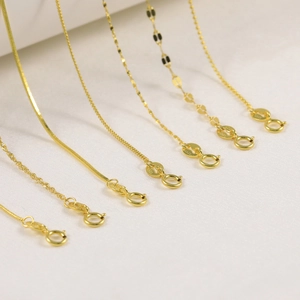 Macro shot of assorted S925 sterling silver gold plated snake and bead chain necklaces