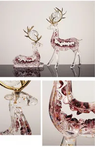 Macro detail of glass elk statue with red crystal stones and gold foil flakes inside