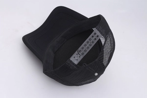Detail view of black mesh baseball cap with breathable fabric and plastic snapback closure