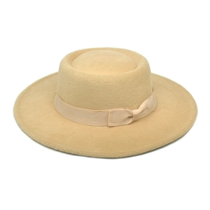 Detail of wool felt fedora hat showing beige ribbon band and flat bow decoration