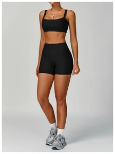 Detailed view of women's ribbed high waist fitness shorts and thin strap sports bra set