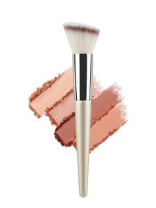 Detail of angled champagne makeup brush with dual-tone bristles and metallic handle