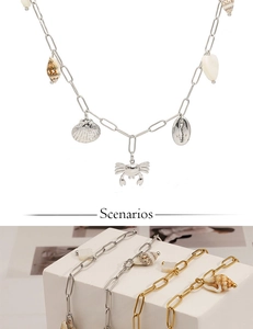 Detailed view of marine series necklaces featuring crab, conch and shell pendants