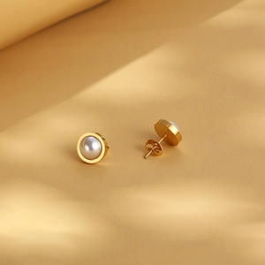 Elegant gold-tone titanium earrings with white pearls for a professional minimalist look
