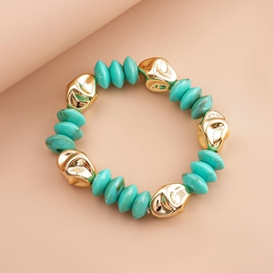 Detail view of turquoise irregular beads and high-shine gold metallic textured elements
