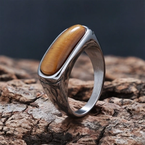 Macro shot of oval tiger eye stone inlay on vintage style stainless steel ring for men