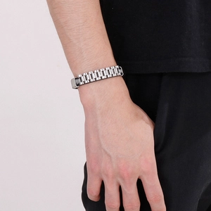 Close-up of men's silver titanium steel bracelet featuring a watch band style link design