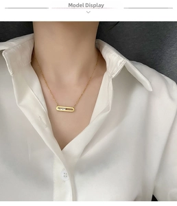 Detail of 18K gold plated necklace featuring a rectangular pendant with three moving zircons
