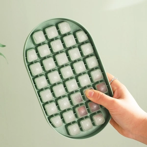 Green silicone ice cube tray with flexible bottom for easy release of small square ice