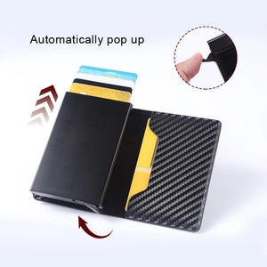 Detail of slim carbon fiber wallet featuring an automatic pop-up card mechanism function