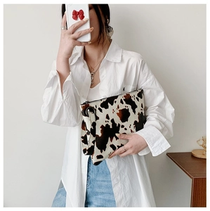 Minimalist women's cow print envelope clutch bag with wristlet strap for street style