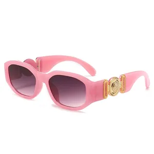 Pink retro rectangle sunglasses with large gold metal medusa medallion on temples