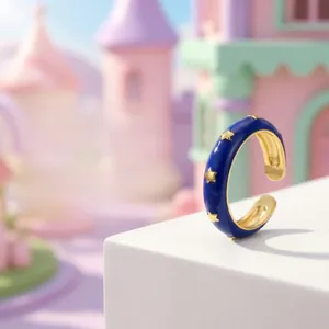 Detail of 18K gold plated star ring featuring deep blue enamel and open-band design
