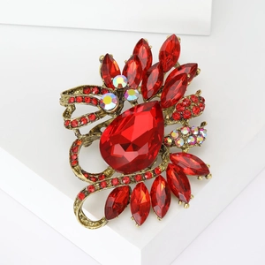 Macro shot of large red teardrop crystal brooch with vintage gold alloy setting