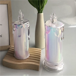 Detailed view of iridescent LED candles with dripping wax effect on wooden wave base