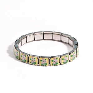 Macro detail of Italian charm bracelet with pink flower pattern on stainless steel links