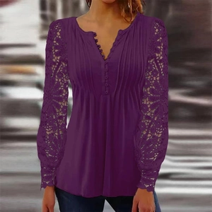 Close-up of elegant V-neck button detail and floral lace sleeves on deep purple top