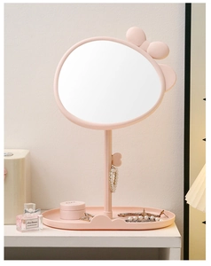 Pink desk makeup mirror with cute rabbit ears and storage base tray on a white shelf