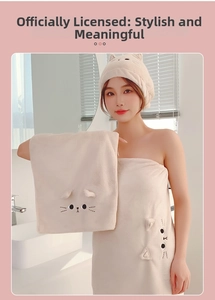 Detail view of the soft coral fleece cat embroidery and 3D ears on the towel set