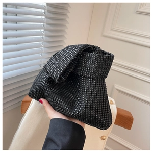 Detail of a black rhinestone clutch bag with a knotted handle for formal evening events