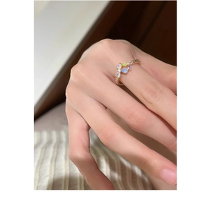Detail of s925 silver flower ring with teardrop opals and colorful gemstones worn on hand