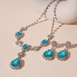 Macro shot of silver vintage teardrop jewelry set with ocean blue gems and small diamonds