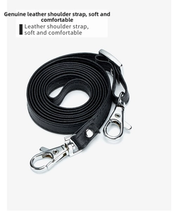Detail showing the black litchi pattern leather shoulder strap with silver lobster clasps