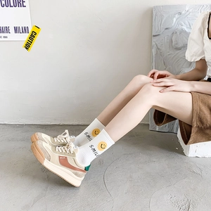 Minimalist beige and green patchwork leather sneakers with stylish smiling cartoon socks