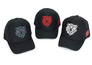 Detailed close-up of tiger embroidery and mesh texture on three trucker caps