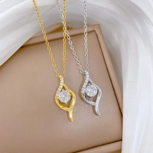 Elegant gold and silver teardrop necklaces with circular crystal inlay on silk fabric