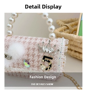 Detail view of pink houndstooth bag with pearl handle and crown rhinestone brooch