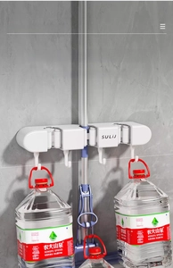Heavy-duty wall-mounted mop holder showing strong capacity with suspended weights