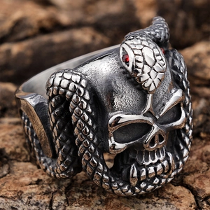 Gothic punk skull cobra ring in antique silver with red rhinestone eyes on tree bark