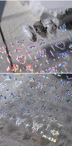Makro-Detail von M-436 holografischen Nagelstickern mit Schmetterling und Herz-Motiven