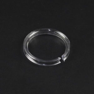 Transparent acrylic bracelet display stand with ring slot on a black background