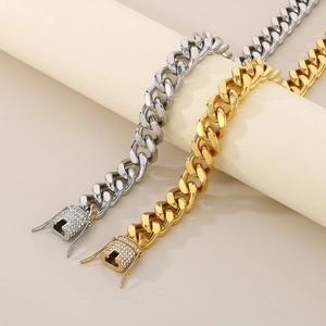 Close-up of gold and silver Cuban link bracelets with sparkling diamond-set square clasps