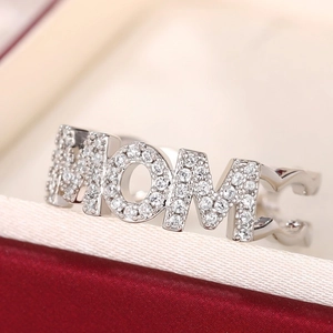 Macro shot of silver MOM ring with pavé stones on red gift box with white silk