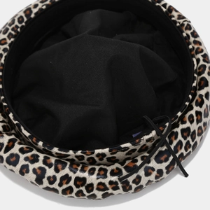 Close-up of leopard print beret interior featuring black fabric lining and adjustable drawstring