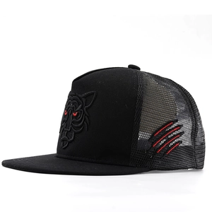 Detail of tiger head embroidery and red claw marks on black mesh trucker cap