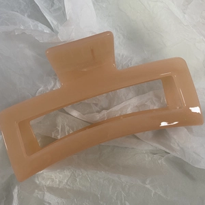 Close-up of extra large 13cm jelly pink rectangular claw clip with hollow geometric design