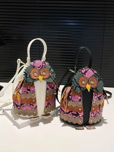 Ethnic style owl bucket bag in black and white with vibrant patchwork and gold rivet eyes