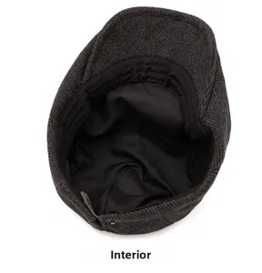 Internal view of dark grey herringbone newsboy cap showing silk lining and stitching