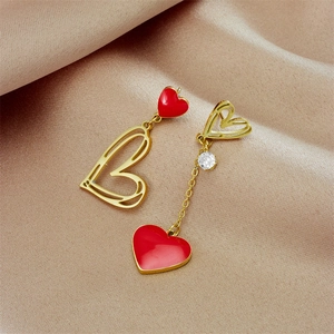 Asymmetric heart earrings with red enamel and gold hollow charms on champagne silk