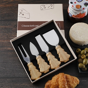 Detail of 4-piece stainless steel cheese knife set with Christmas tree wooden handles