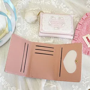 Cute pink trifold wallet for girls with rabbit pattern, pompom, and heart ID window