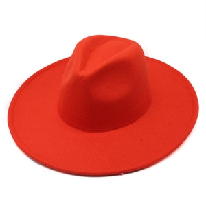Detailed view of a bright red wool fedora with a wide flat brim design